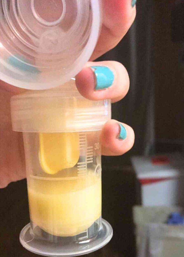 surrogate mother holding bottle of breastmilk that she pumped for the surrogate baby