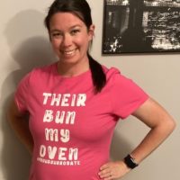 iowa surrogate wearing shirt that reads "their bun my oven"