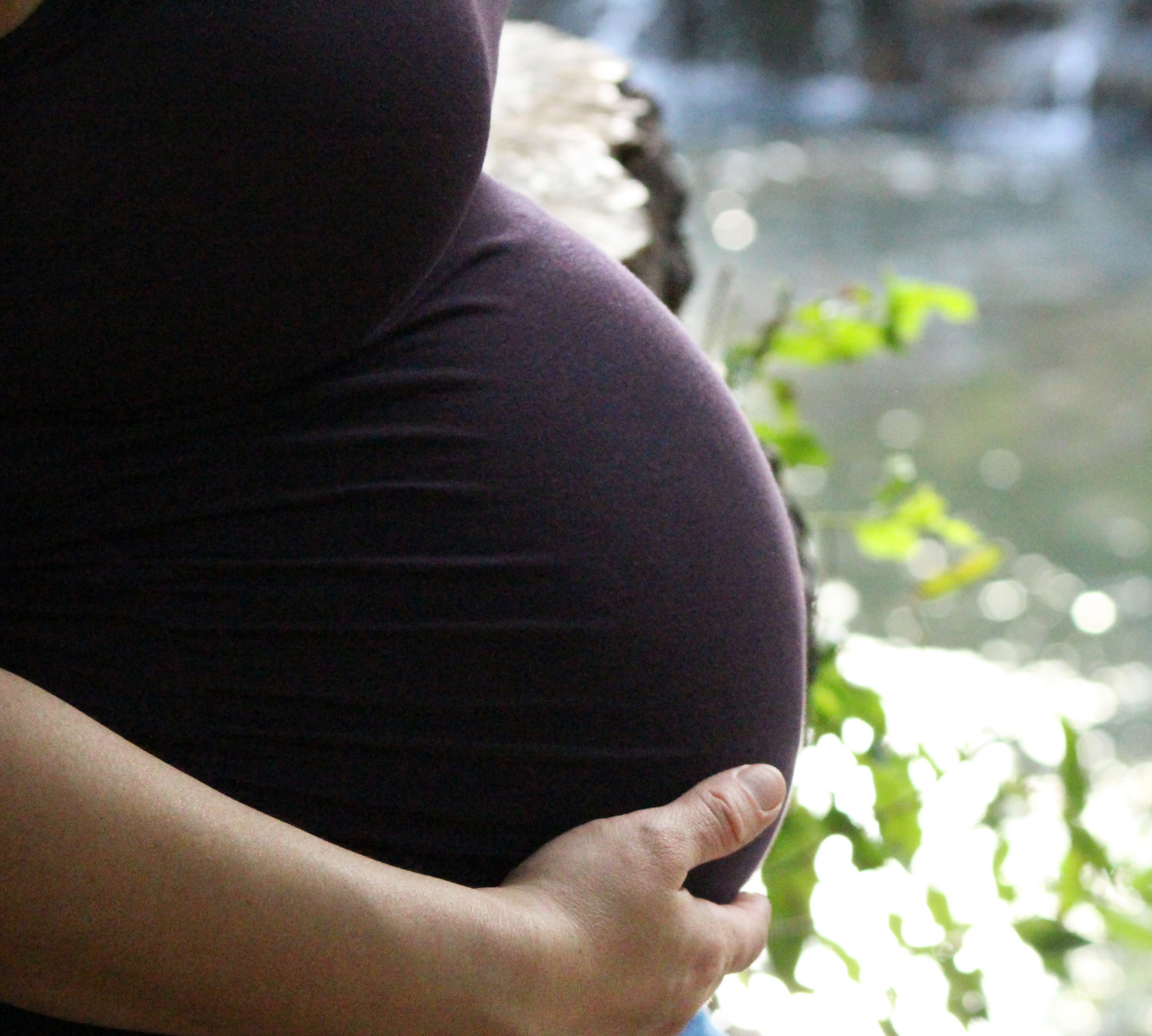 Minnesota surrogate mother holding surrogacy pregnancy bump