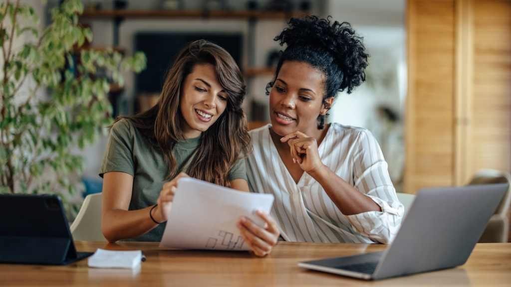 black surrogate mother reviewing gestational carrier agreement with Latina surrogacy attorney