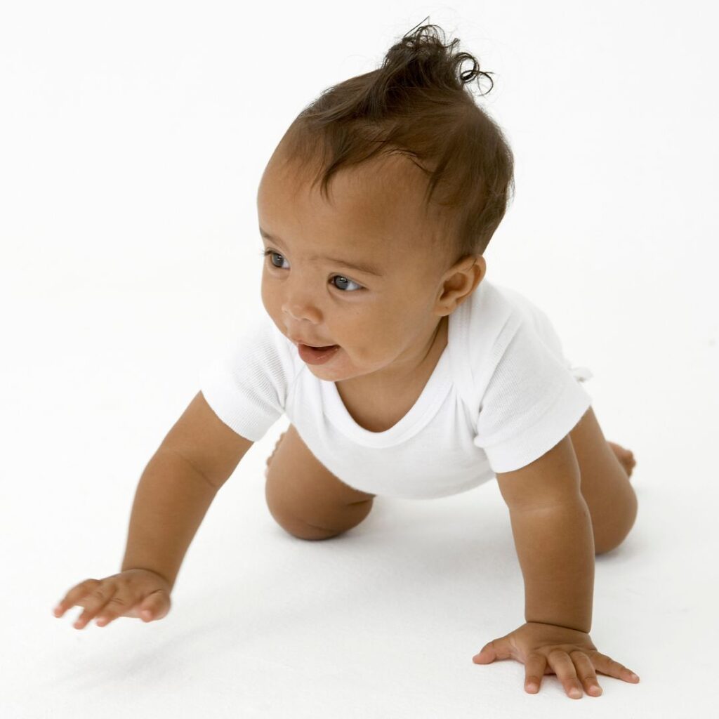 Black baby born through surrogacy, crawling.