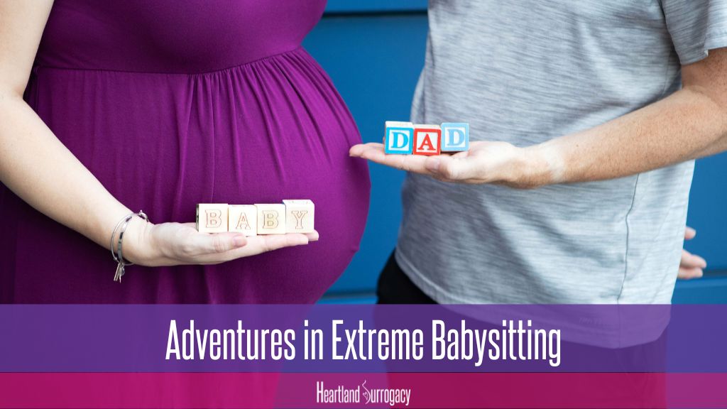 surrogate holding blocks that read "baby" and intended father holding blocks that read "dad"