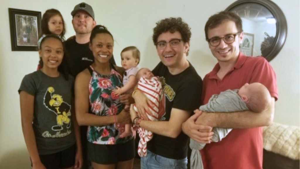 Black surrogate pictured with her family and the family she helped build